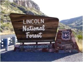Wooden sign at the entrance to the Lincoln National Forest.